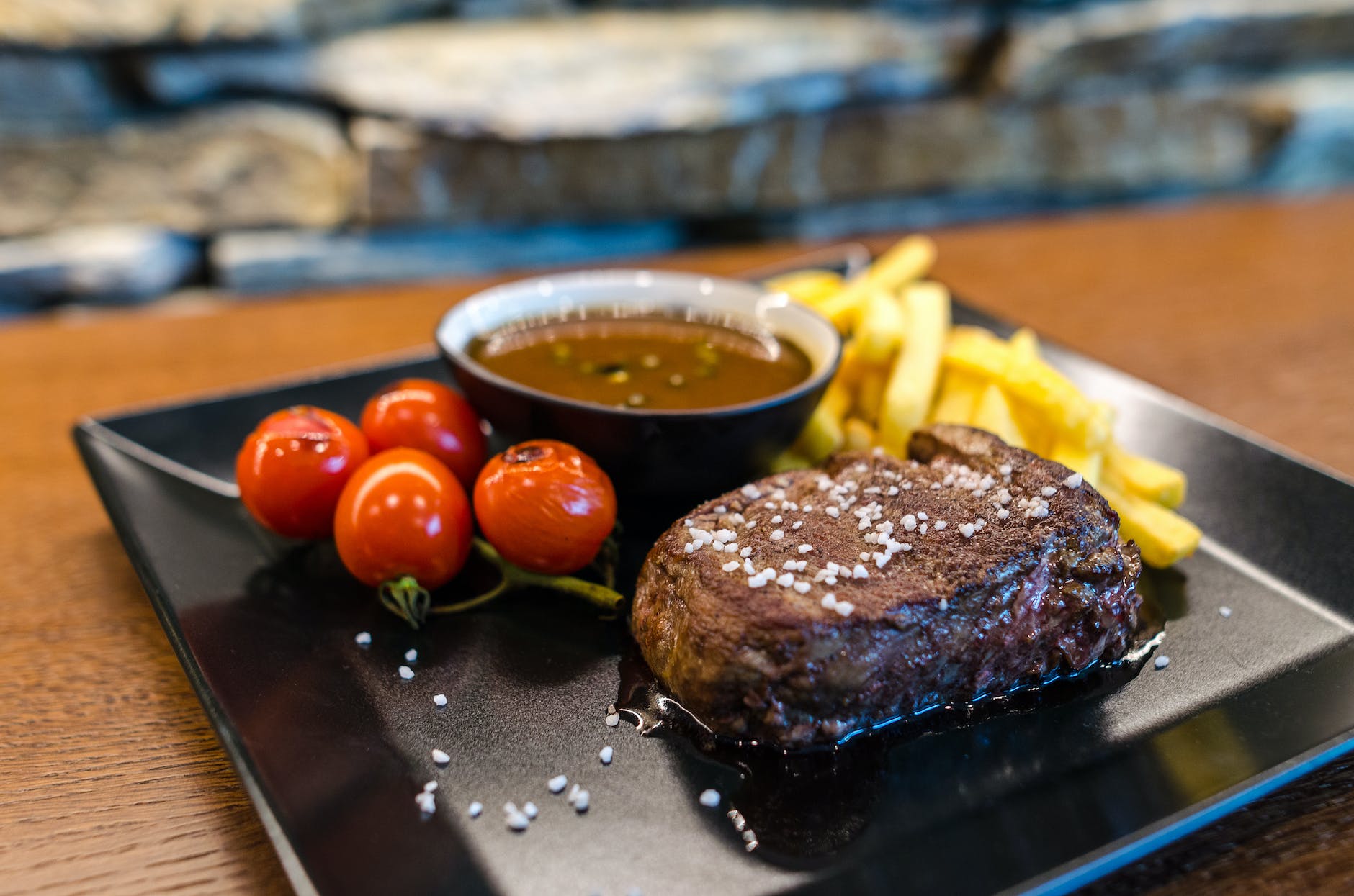 steak with french fries and red fruits