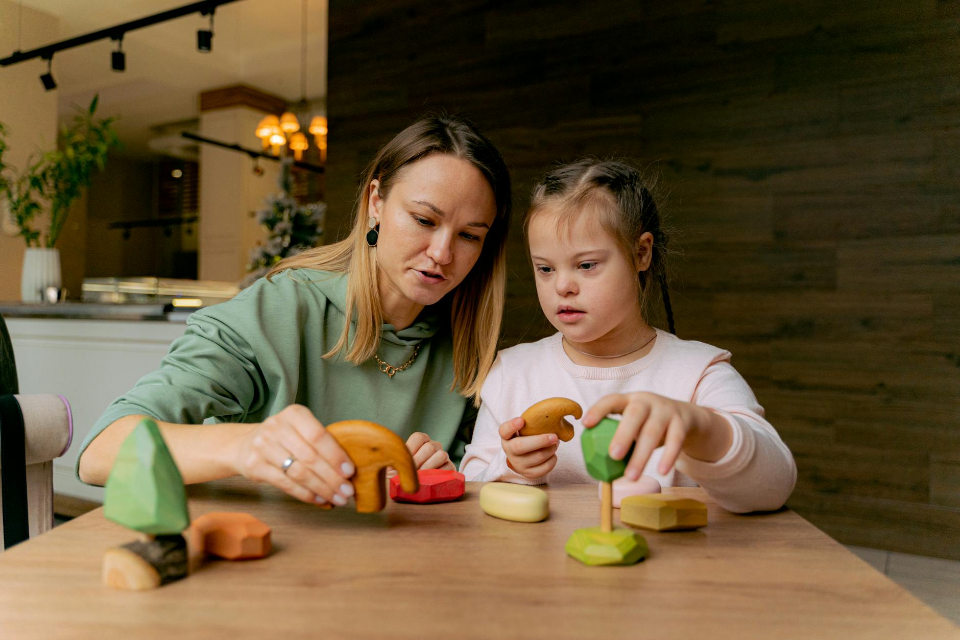 a mother and girl playing toys together