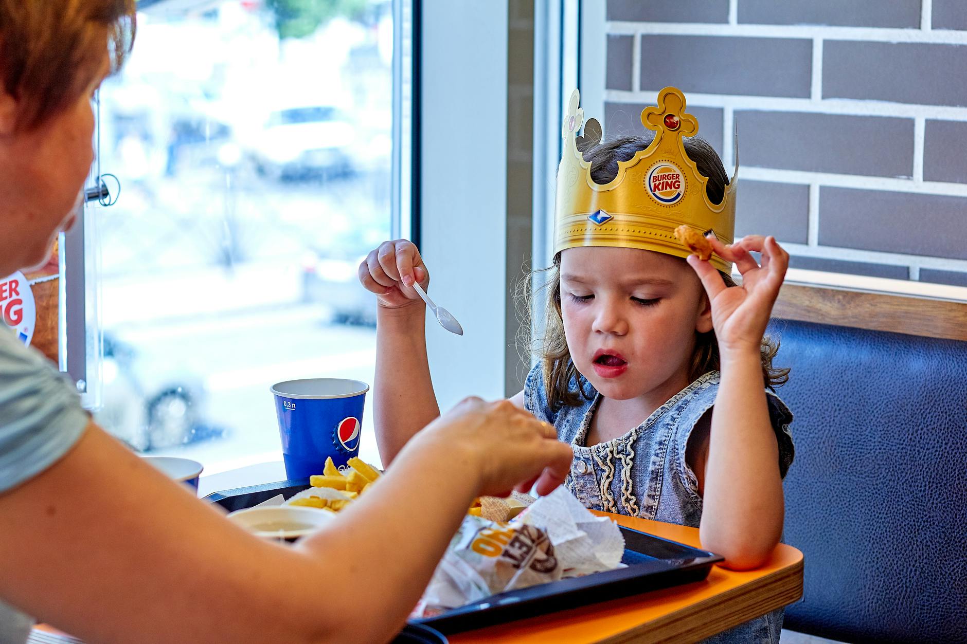 a girl eating at burger king