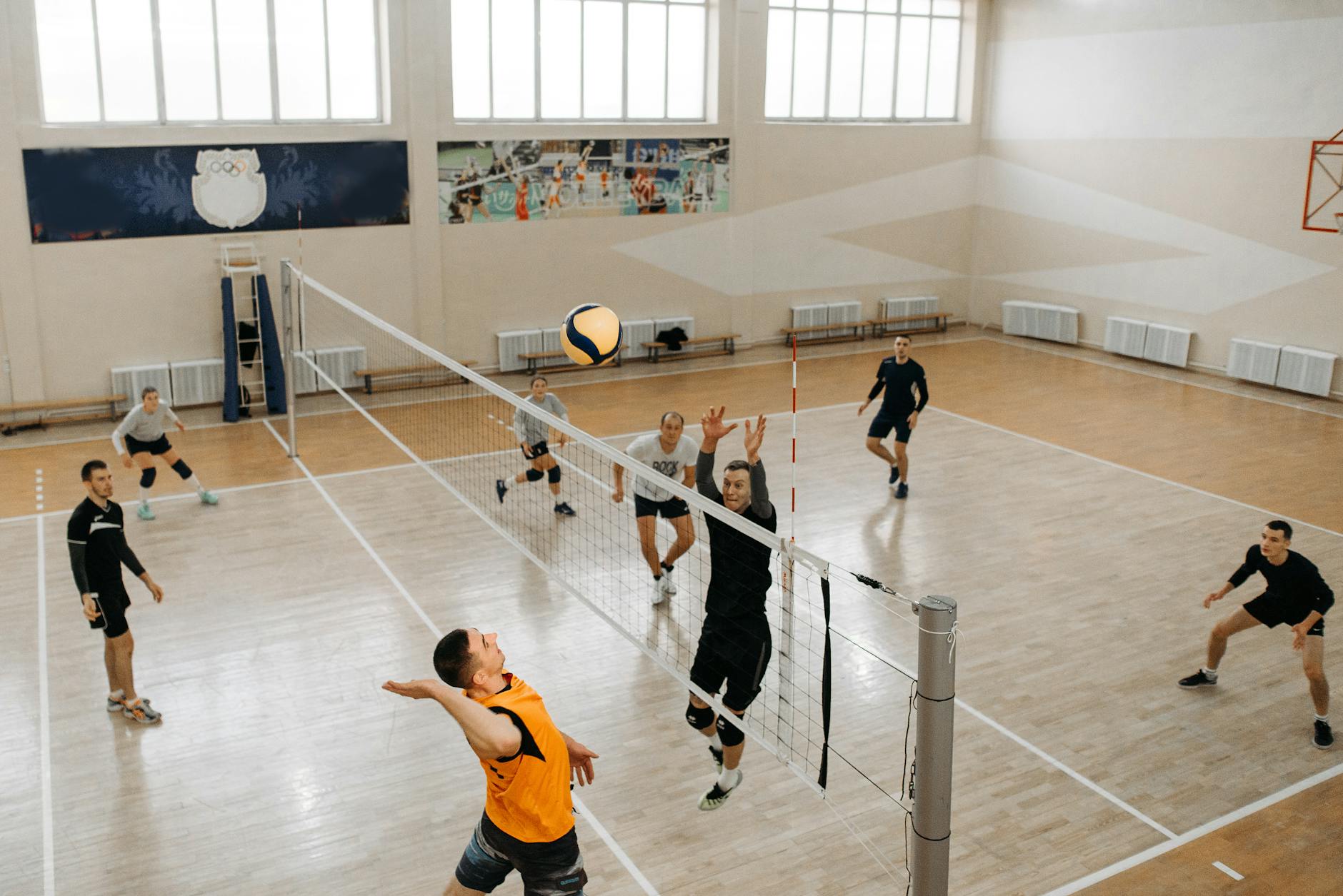 player jumping near net with arms raised