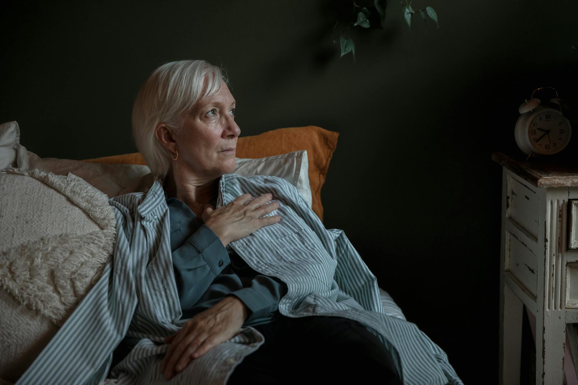 woman sitting on a bed looking up